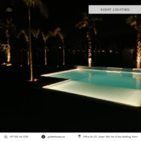 Illuminated swimming pool and palm trees with ambient night lighting in Dubai.