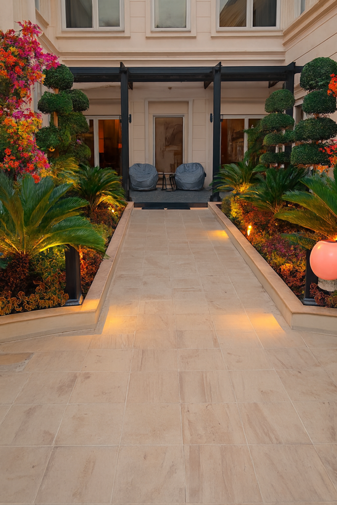 "Luxury villa backyard with elegant landscaping, flowering plants, topiary trees, and ambient lighting"