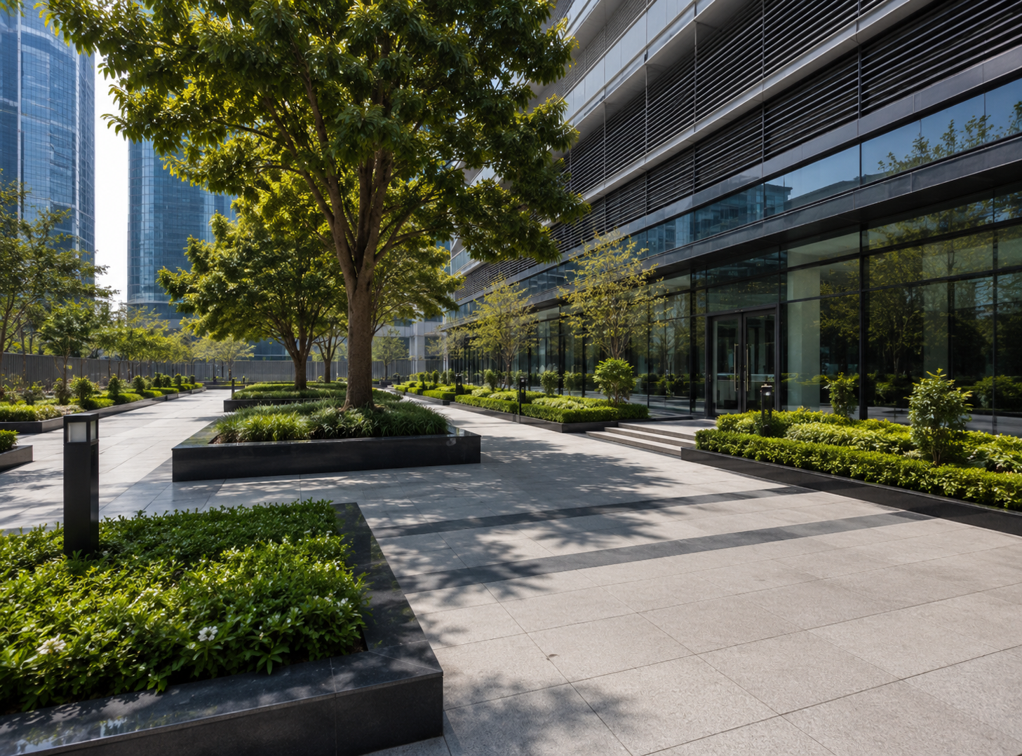 Modern commercial landscaping in Dubai featuring office buildings, landscaped gardens, mature trees, manicured hedges, paved walkways, and premium outdoor green spaces.